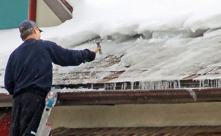 removing an ice dam to prevent water damage in aspen, colorado