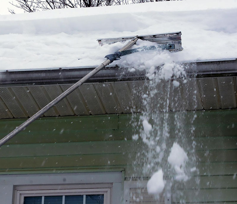 snow removal from roof with a snow rake